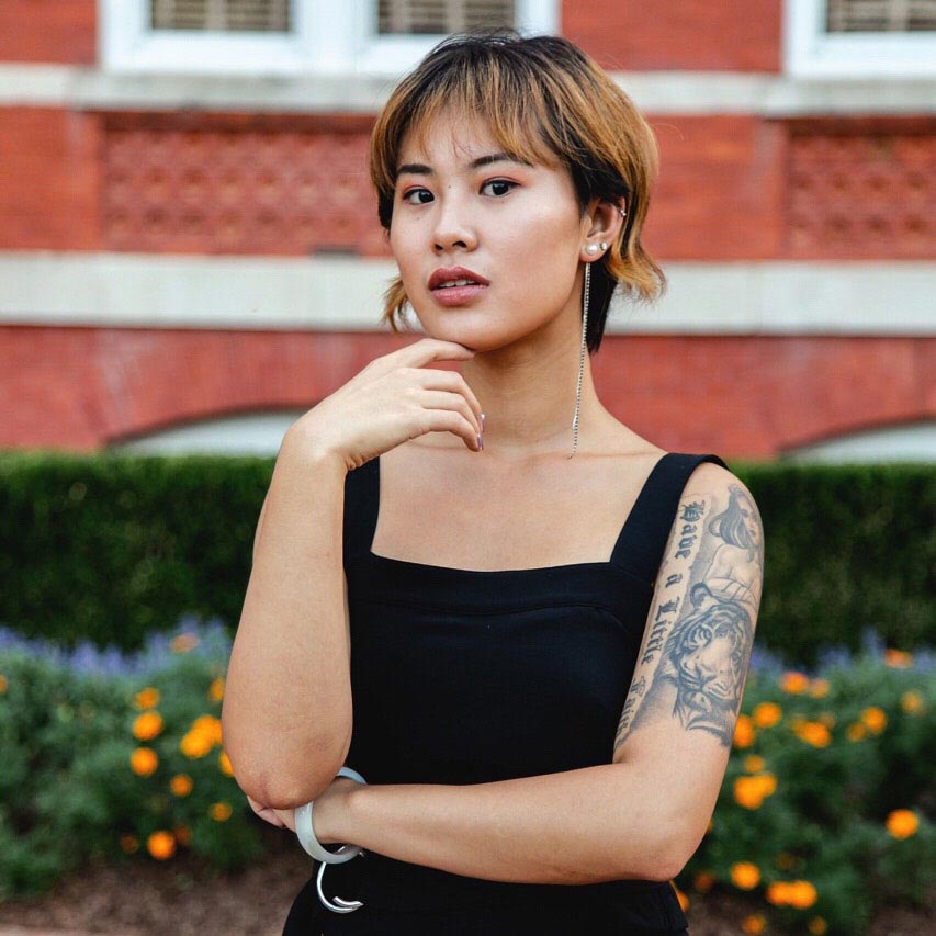 Menglin standing in front of Samford Hall in a black sleeveless dress.