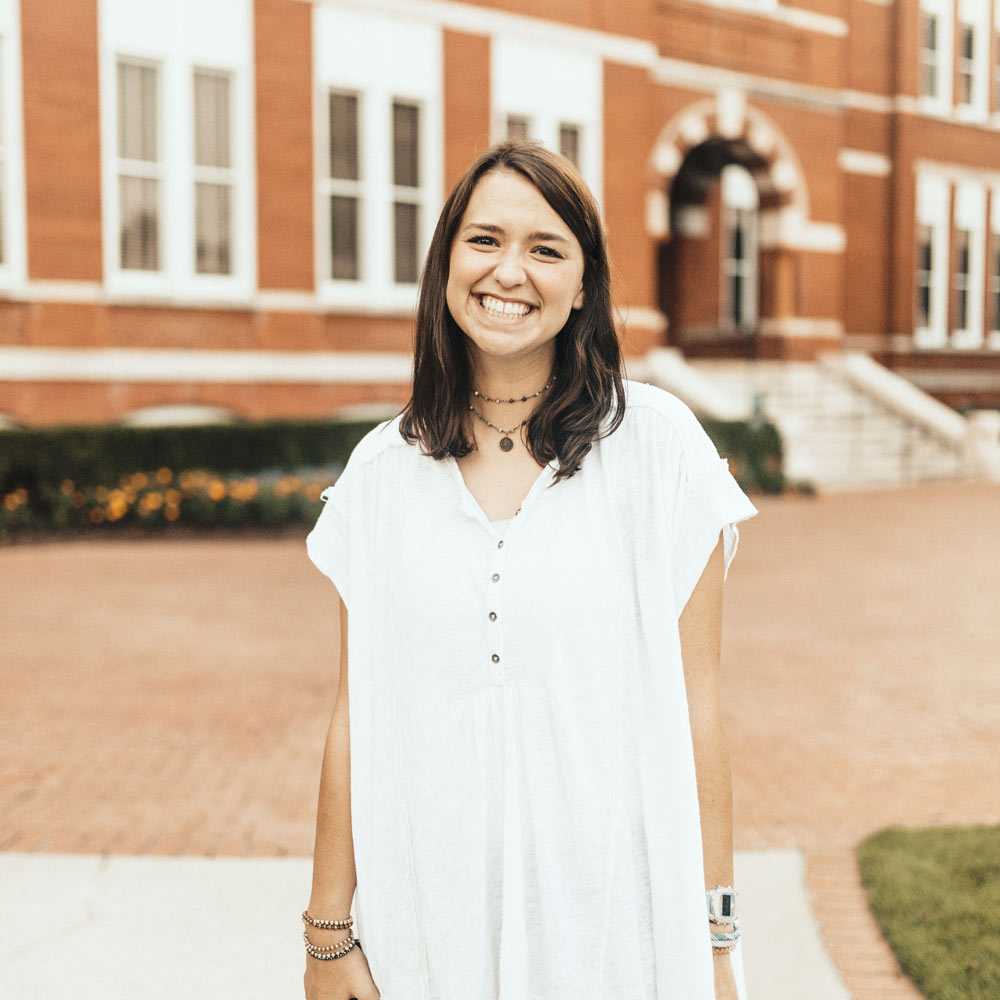 Carson Martindale standing in a white shirt in front of Samford Hall