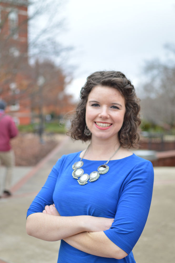 Chaffin Hart with arms folded in a royal blue dress.