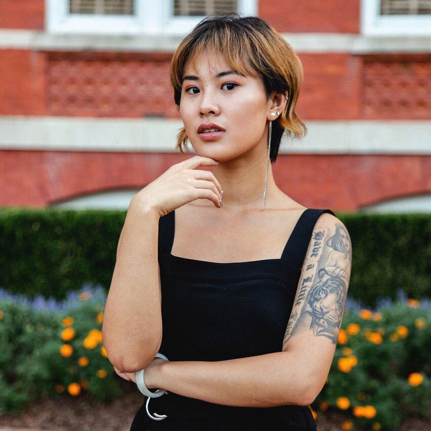 Menglin Wei standing in front of Samford Hall in a black sleeveless dress.