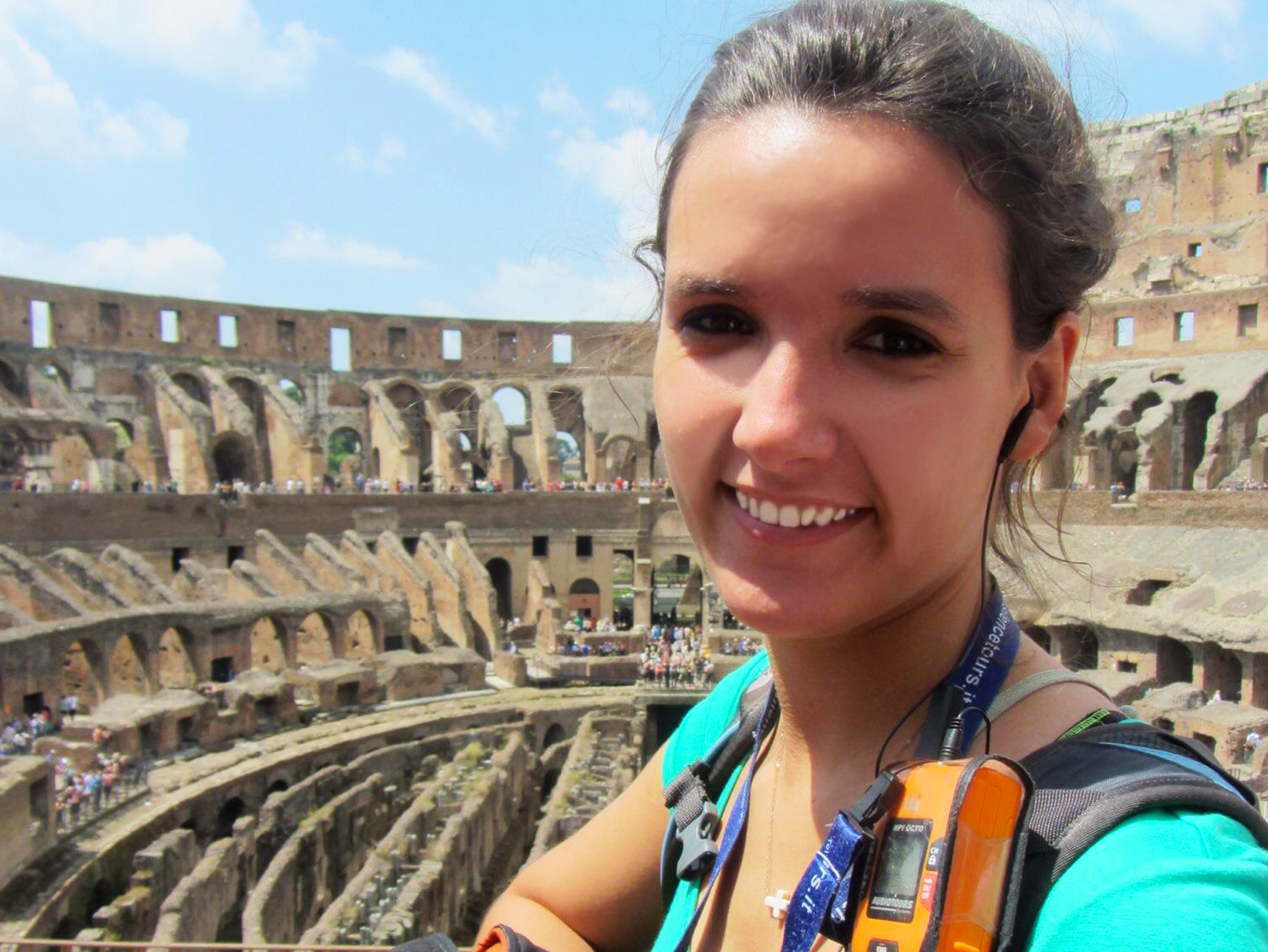 Study Abroad student selfie with The Colosseum, Rome in the background.