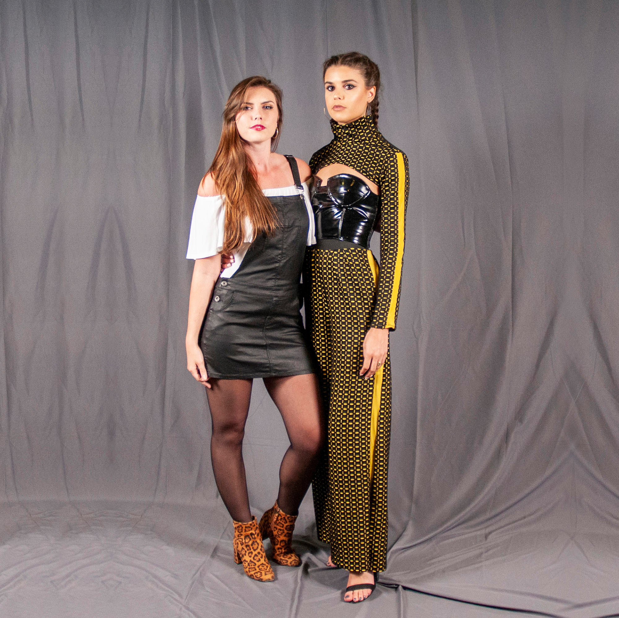 Designer and Model posing together at the backstage photo screen.