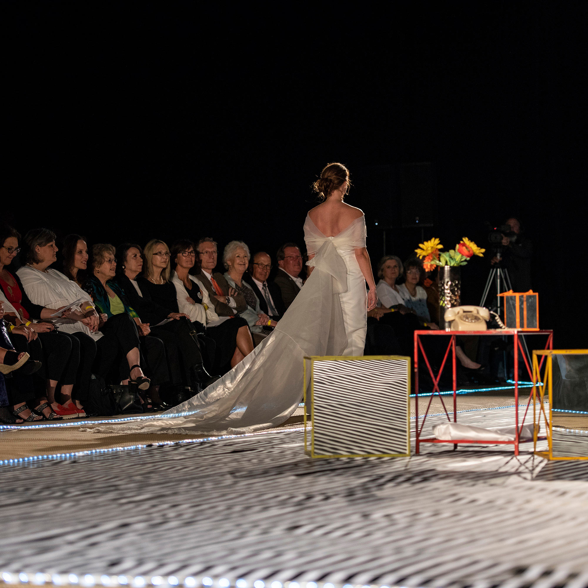 Model walking the runway in a bridal dress with a lengthy train during The Fashion Event: Mod.