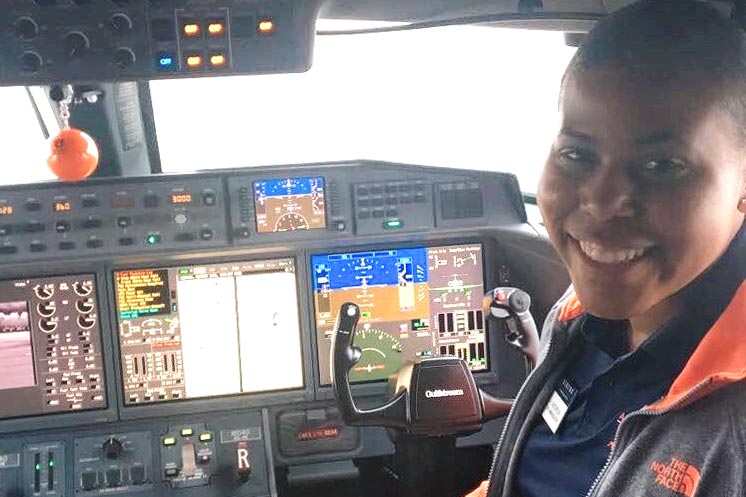 Photo of Asia Anchrum in the cockpit of the plane.
