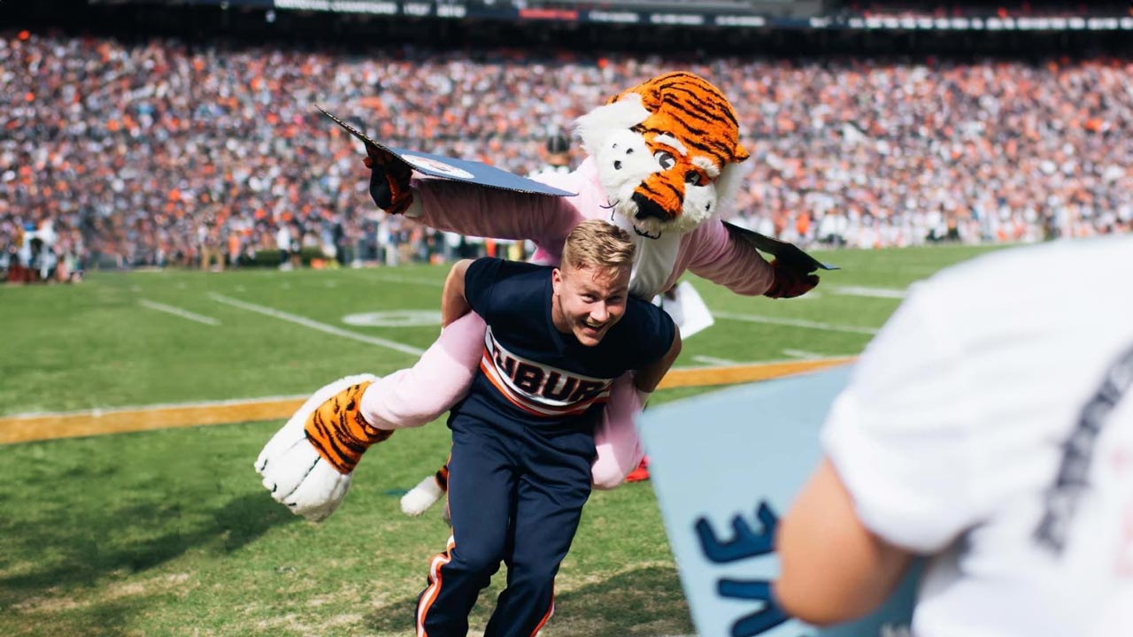  Daniel Martin with Aubie on his back like an airplane.