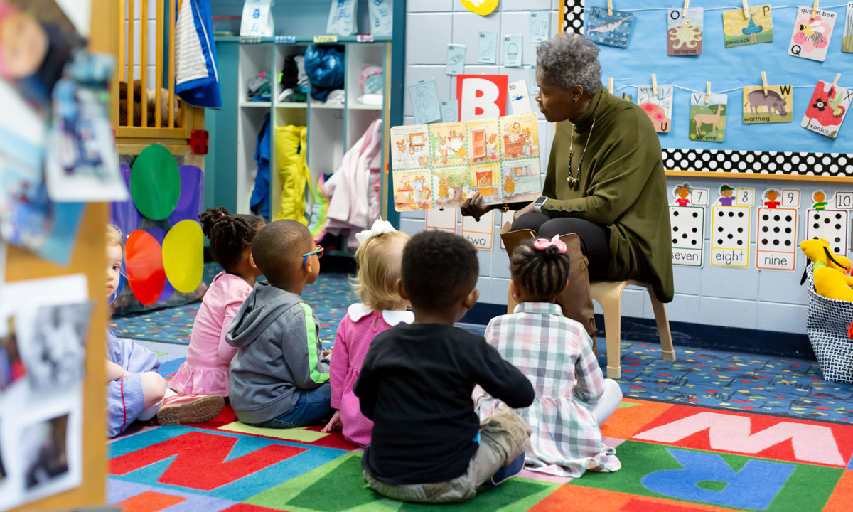 Photo of teacher reading to students.