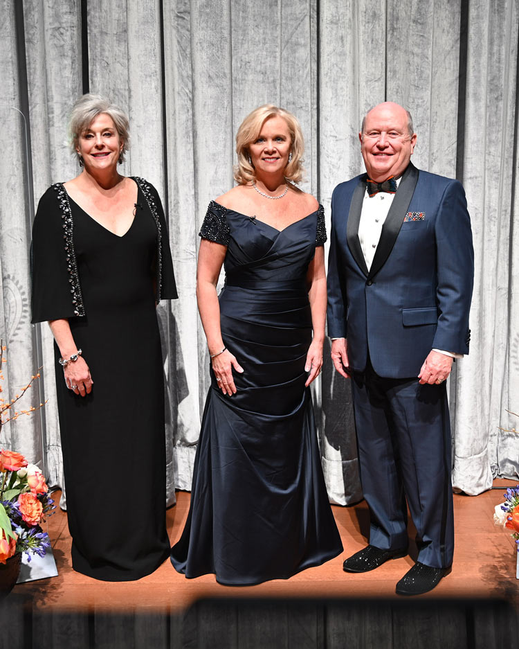 Photo of Beth, Susan and Nick dressed in formal wear.
