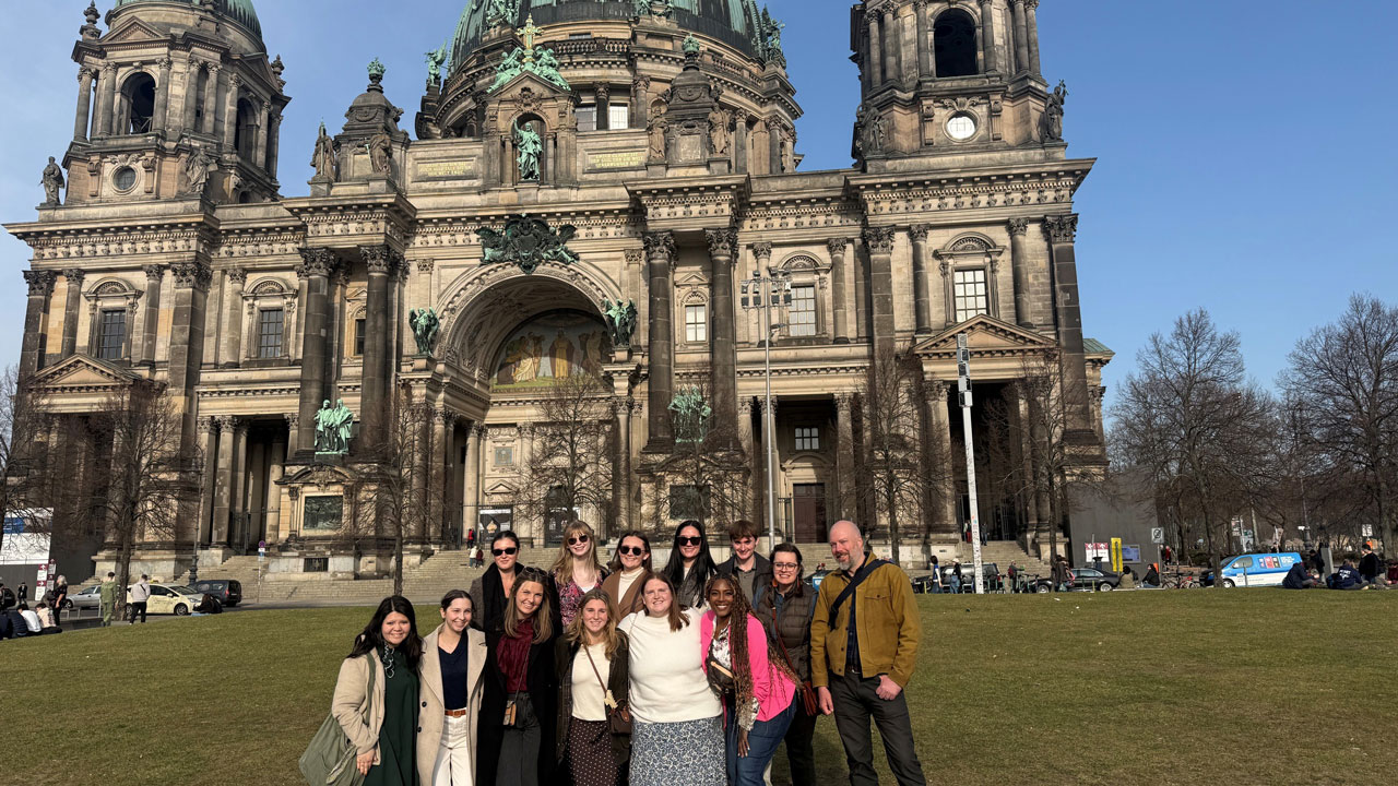 students standing in front of ancient building