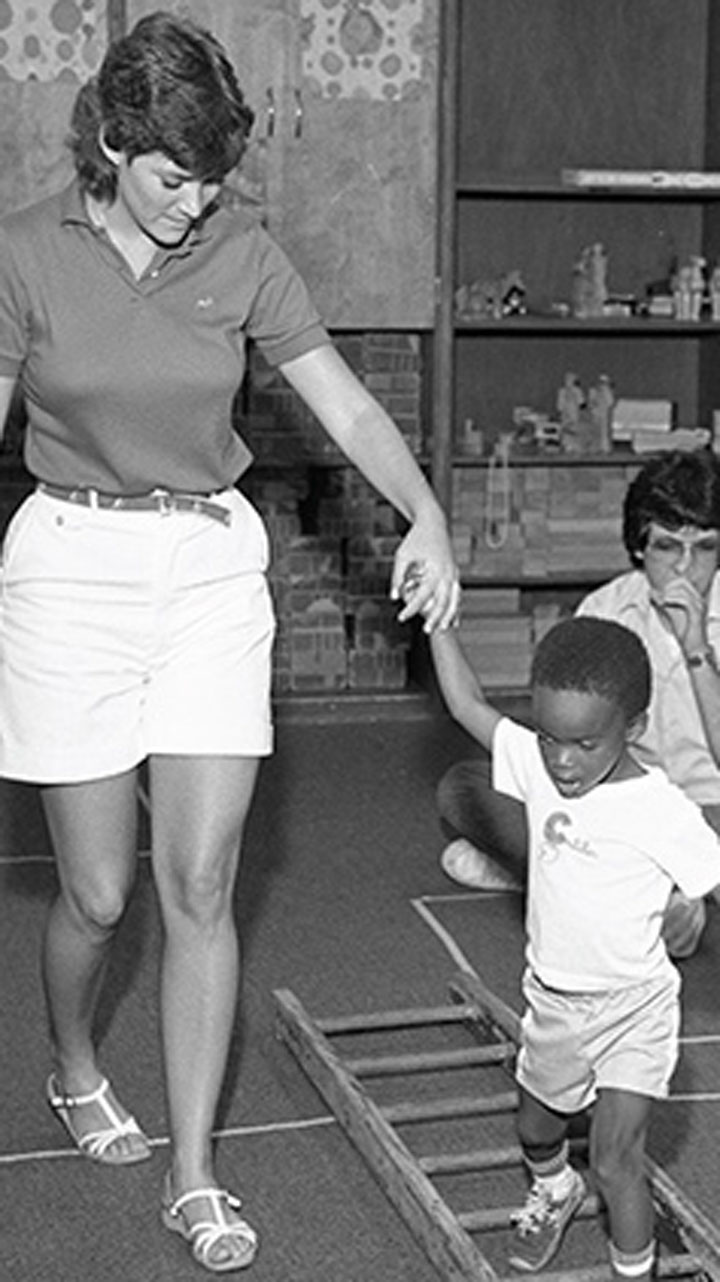 student holding teachers hands