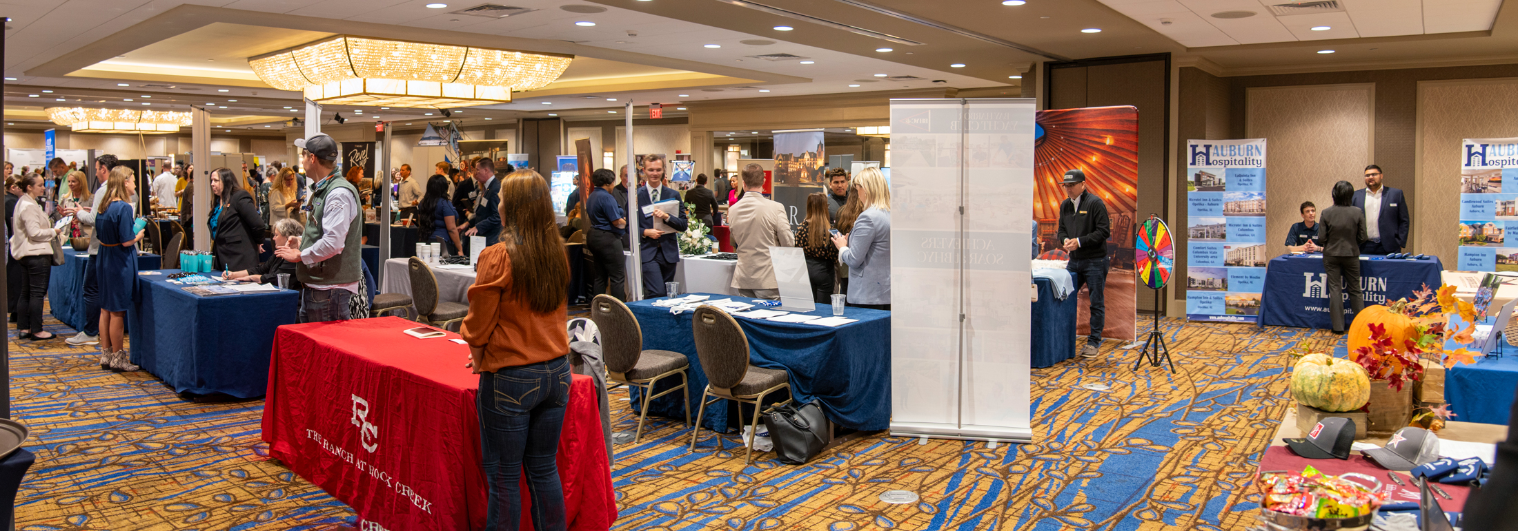 Photo from the 2022 Hospitlaity Management Career Fair with a crowd of students and people.