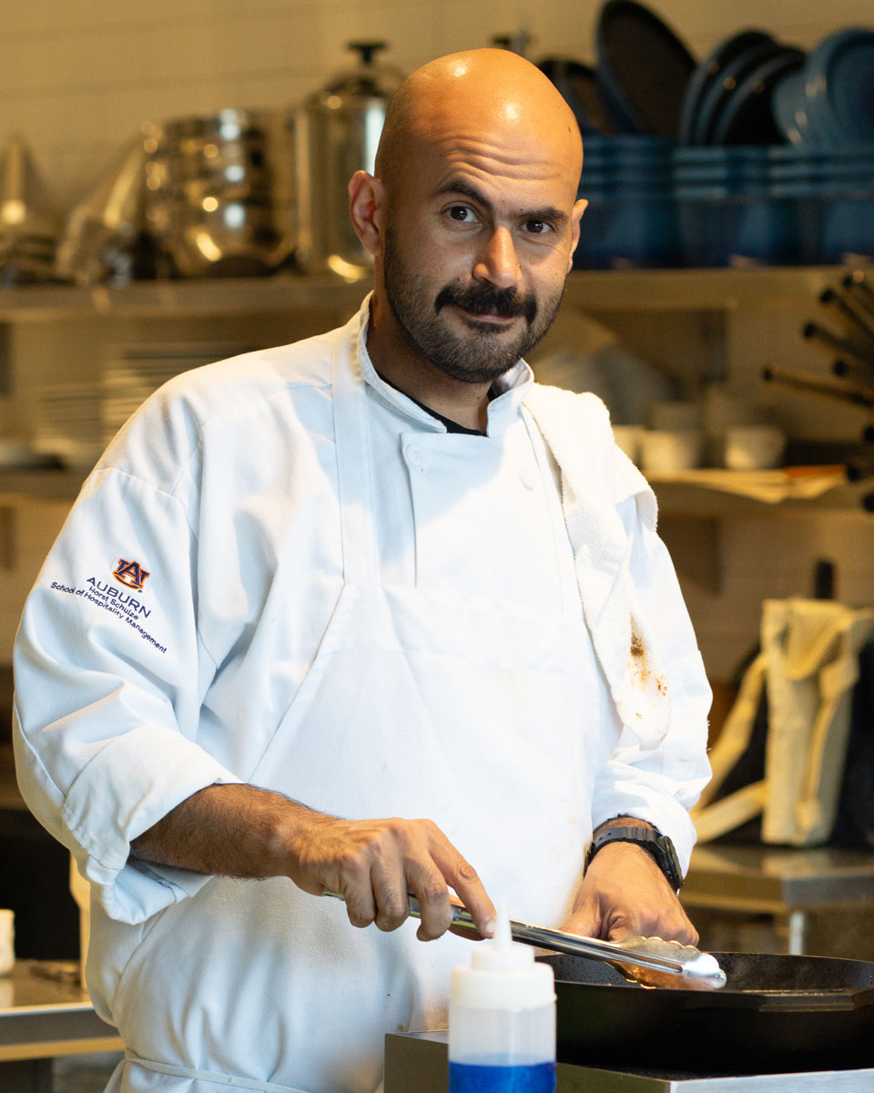 Chef Ammar in the culinary lab cooking