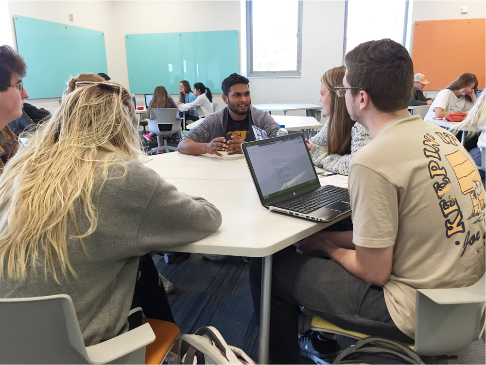 Joshua Prasad talking to a group of students.