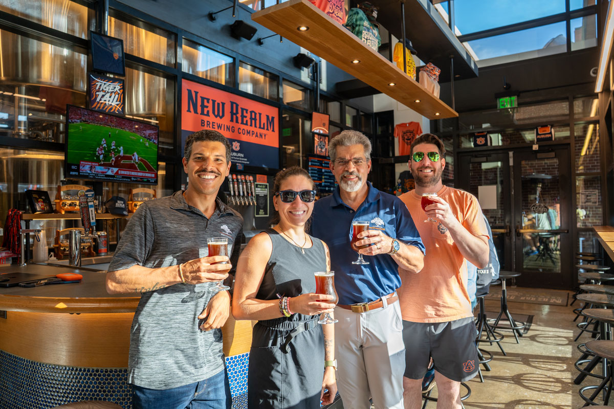 Four people holding beer