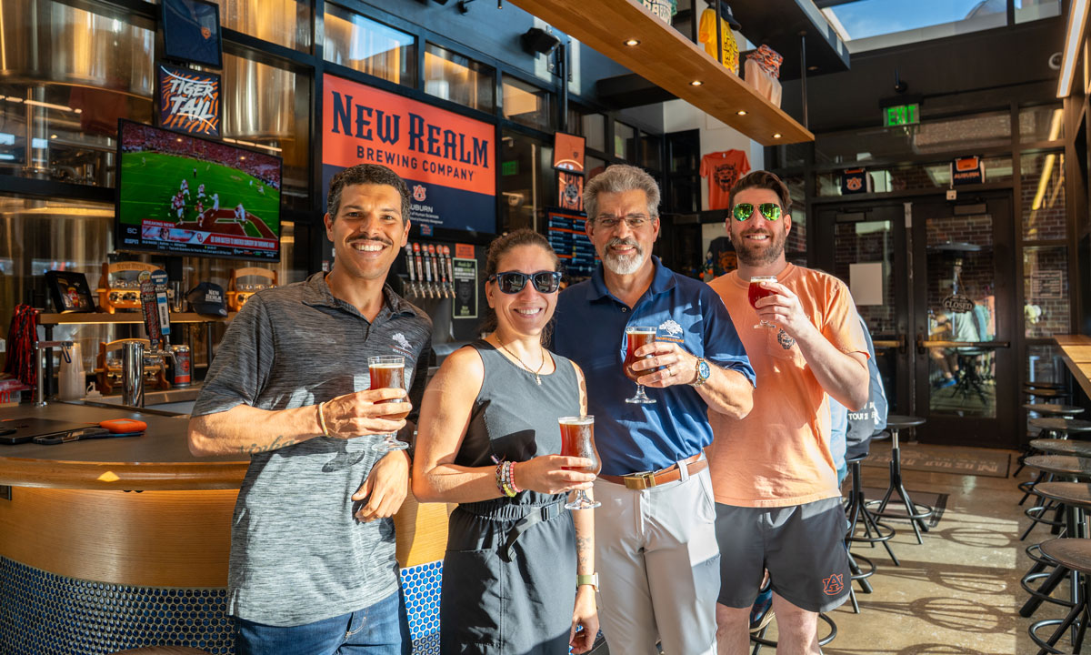 Four people holding beer
