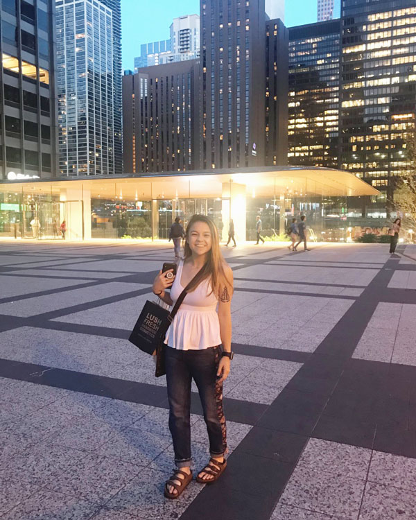 Taylor Blain standing in front of a hotel entrance.