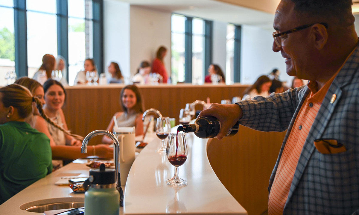 Photo of Thomas Price pouring wine